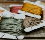 green and yellow yarn on brown wooden table